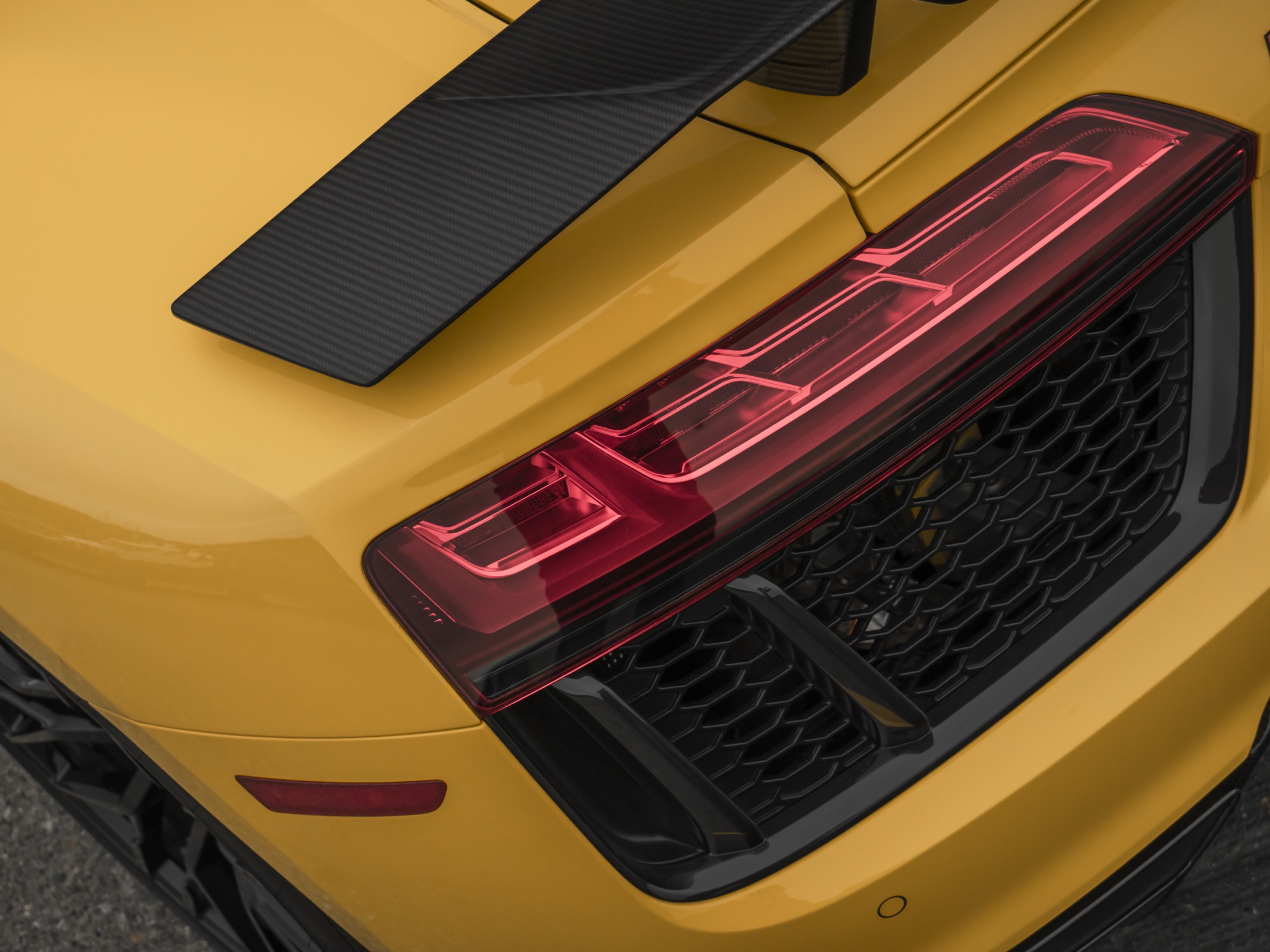 Close view of a yellow Audi taillight and rear wing