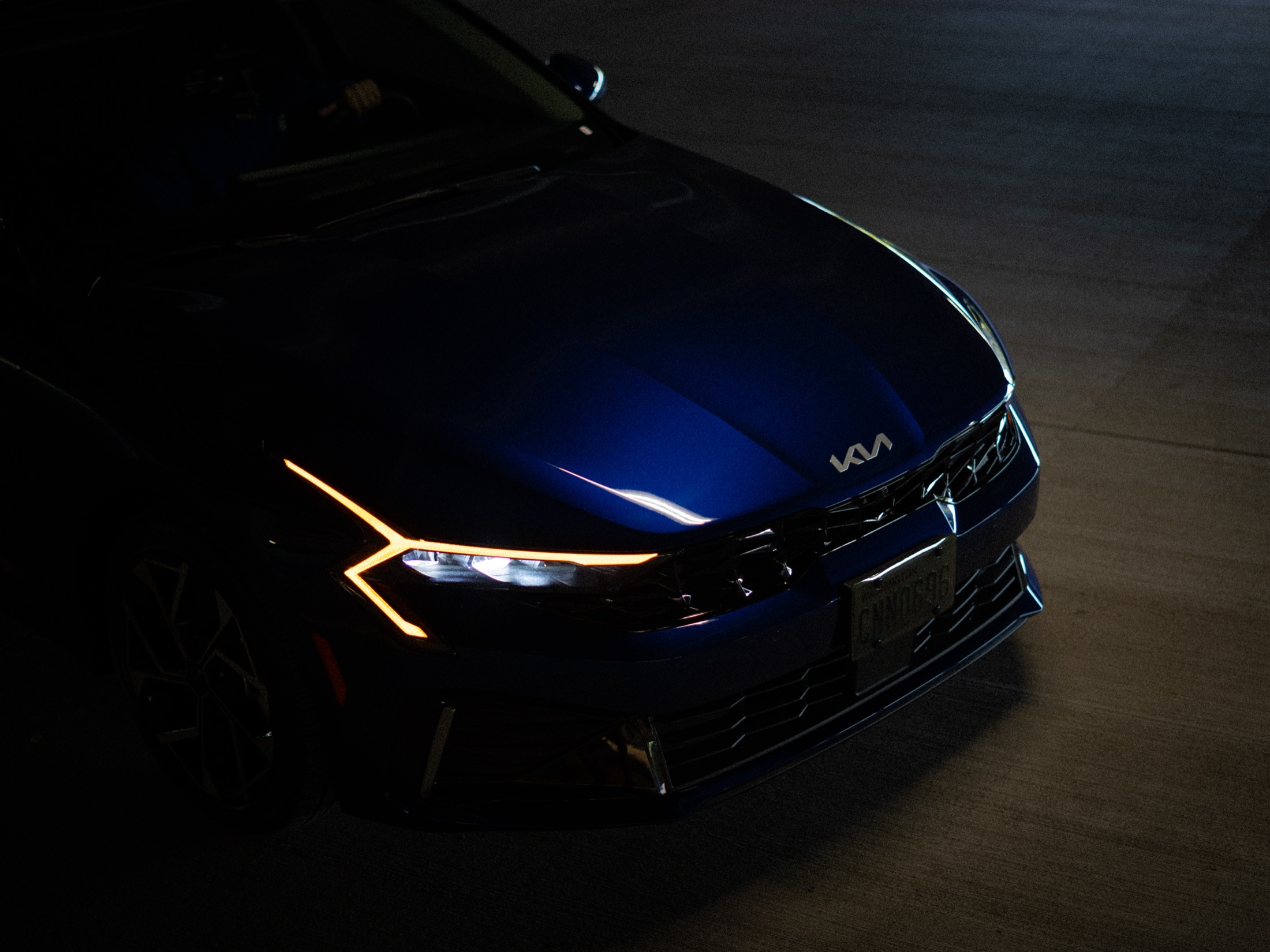 Blue car emerging from deep shadow
