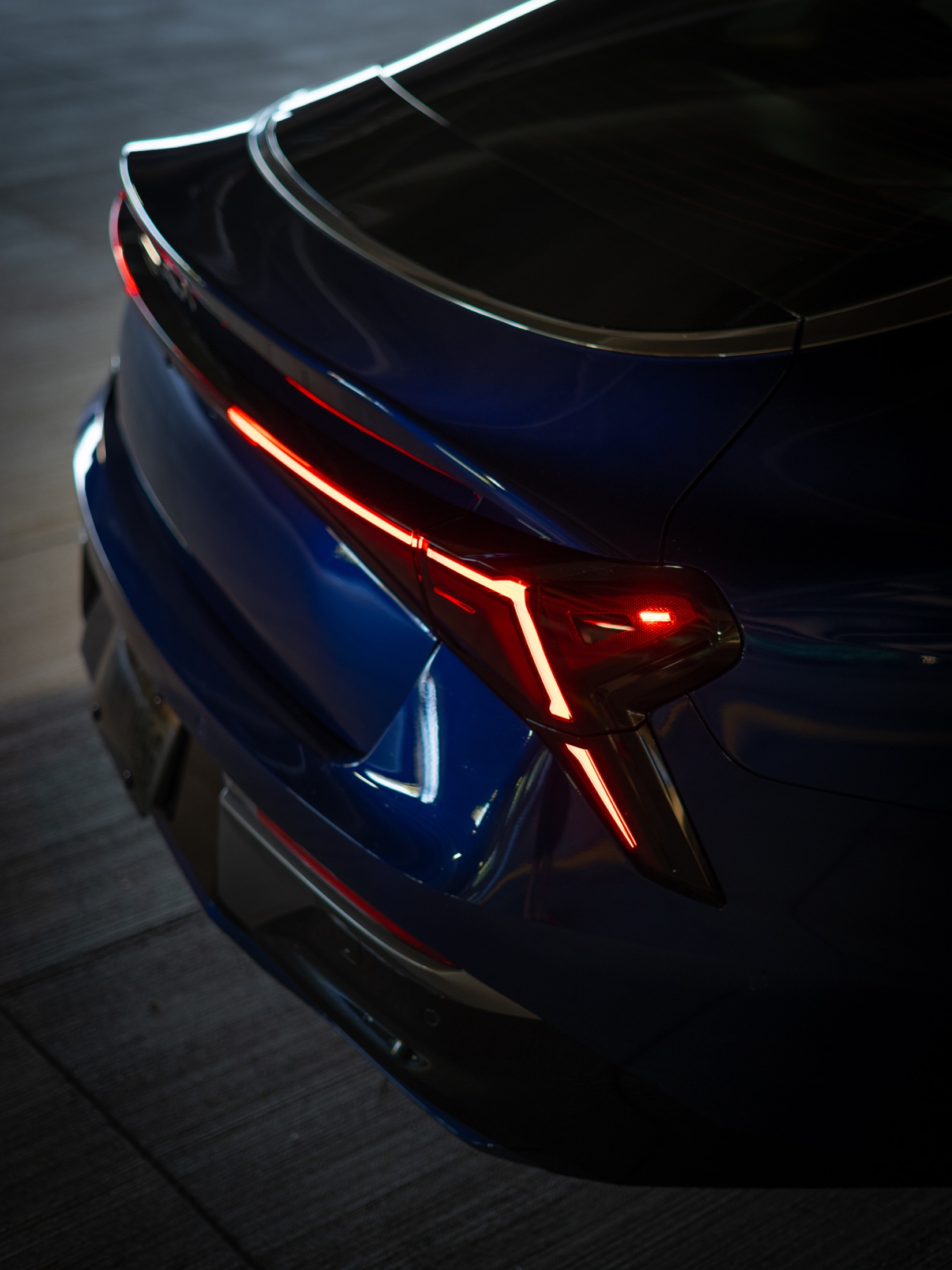 Blue car taillight glowing in a dark garage